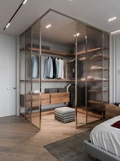 a bedroom with mirrored closet doors and wooden furniture in the corner, along with a footstool