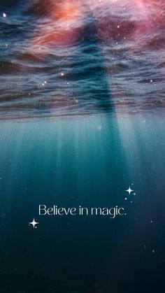 an underwater scene with the words believe in magic above it's water surface and stars