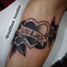 a black and white tattoo on the arm of a person with a heart shaped ribbon