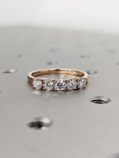 a diamond ring sitting on top of a metal surface