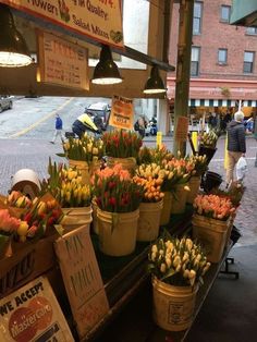 flowers are on display at an outdoor market