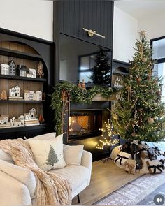 a living room filled with furniture and a christmas tree in front of a fire place