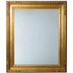 a gold framed mirror on a white wall