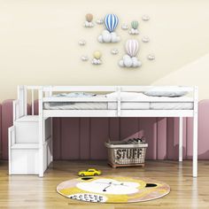 a white bunk bed sitting on top of a hard wood floor next to a pink wall