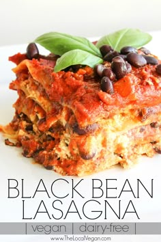 black bean lasagna on a white plate with basil leaves and text overlay