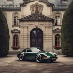 a green car parked in front of a large building with trees and bushes around it