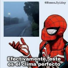 a spider man is standing on the side of the road with his hands up in front of him