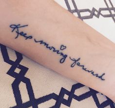 a person with a tattoo on their arm that says, keep moving toward you