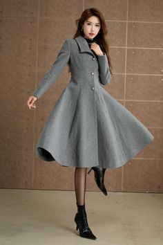 Elevate your winter wardrobe with this classic gray wool coat. Designed with a fitted bodice and a flared A-line skirt, this coat offers a flattering silhouette that exudes elegance.This coat is a must-have for your seasonal collection. DETAIL * 50% wool blend, 50% fiber,nylon * Polyester lining * Long sleeve wool coat * Single breasted buttons * Two seam Pockets * Below the Knee Length * Fit and flare coat, dress coat * Perfect for winter, autumn * Dry clean MODEL SIZE Bust 85 cm(33.4") Waist 67 cm(26.7") Height 168cm (5' 6") She wears size XS Choose CUSTOM Order if you * Need a better fit * Can't find your size in our size Chart * Change the Style * Chang the Length * Your Height is not Between 5'1" - 5"9" * Your weight is over 75 kg SIZE GUIDE Size vary between Brand and Country Please Elegant Gray Wool Coat For Office, Fitted Gray Wool Coat For Fall, Gray Winter Wool Coat For Office, Gray Wool Coat For Office In Fall, Fitted Gray Winter Pea Coat, Elegant Gray Wool Coat With Buttons, Fitted Gray Pea Coat For Winter, Gray Fitted Winter Pea Coat, Elegant Gray Winter Outerwear