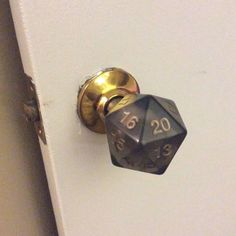 a door knob with a metal dice on it's side and the number twenty