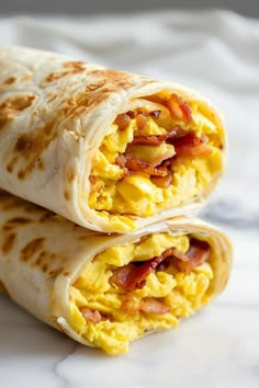 two breakfast burritos are stacked on top of each other