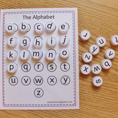 a printable alphabet game with letters and numbers on the table next to it,