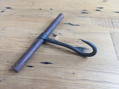 an old wrench lying on top of a wooden table