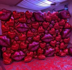 there is a large pile of red foil wrapped bags on the floor in this room