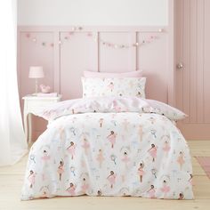 a bedroom with pink walls and bedding decorated in ballerinas on the sheets