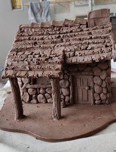 a clay house made to look like it has rocks on the front and side of it