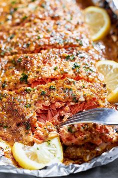 a pan filled with cooked salmon and lemon slices