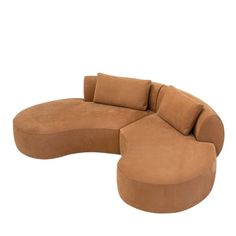 the curved couch is made out of brown fabric and has two pillows on each side