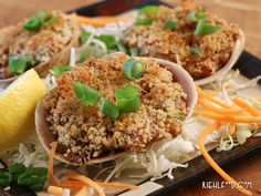 some food is sitting on a tray with lemon wedges