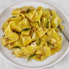 a white plate topped with pasta covered in sauce