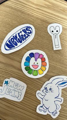 several stickers on a wooden table that say new years