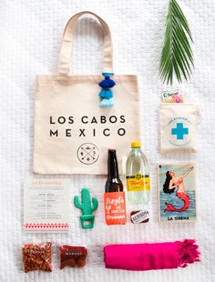 an image of a bag and other items on the bed with text that reads, los cabos mexico