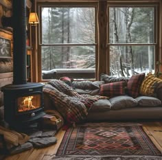 a living room filled with furniture and a fire place in front of a large window