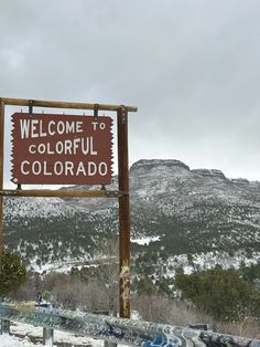 a welcome sign to colorful colorado in the snow