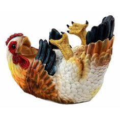 a ceramic rooster figurine sitting on top of a white surface