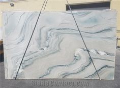 a large slab of marble sitting on top of a parking lot