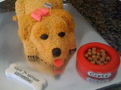 there is a cake made to look like a dog's head and food bowl