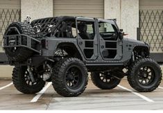 a black jeep parked in a parking lot next to a building with the words starwood motors written on it