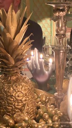 a table with candles and pineapples on it