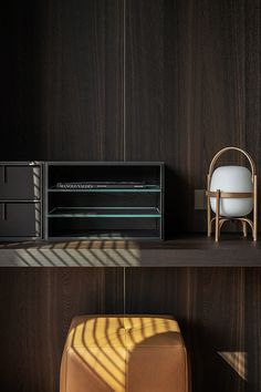 two chairs and a table in a room with dark wood paneling on the walls