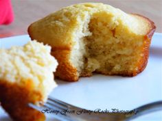 a half eaten muffin sitting on top of a white plate