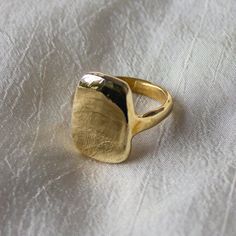 We love this signet ring for the soft, curved lines but strong, bold shape. The irregularity of this heavy ring harkens back to an ancient past.  A thick gold ring that is a weighty and substantial piece of jewelry that will last a lifetime. Our number one bestseller, this beautiful big gold ring is created in recycled metals.  Details: * This modern, organic ring was first created by hand in wax * Available in recycled brass or sterling silver, please read brass ring care and cleaning guides before ordering * Sizes 6-9 kept in stock, inquire for custom sizing * Silver Ingot Ring is made to order, please allow 1-2 weeks to ship  * Read jewelry care instructions below Shop the Solid 14k Gold Ingot Ring. If you love the organic look of thick band rings, check out the Wisdom Ring and the Taro Open Rings Design, Bold Gold Rings, Brass Rings Handmade, Big Gold Ring, Brass Rings Jewelry, Thick Gold Ring, Silver Ingot, Brass Rings, Organic Rings