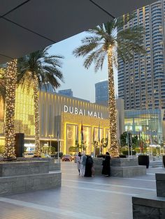 people are walking around in front of the dubai mall