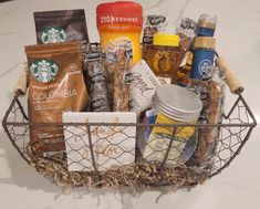 a basket filled with coffee and snacks on top of a counter