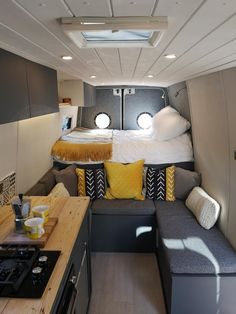 the interior of an rv with a bed and couch