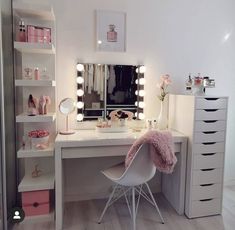 a white desk topped with a mirror and lights