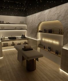 an empty room with shelves and bottles on the wall, lit up by dim lighting