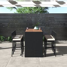 an outdoor dining table and chairs on a patio