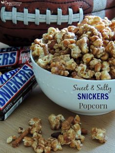 sweet and salty snickkers popcorn in a white bowl with football on the side