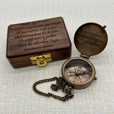 a wooden box with a compass and chain