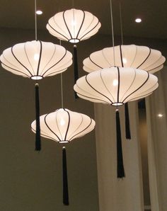 four lights hanging from the ceiling in a room