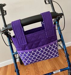 a purple and white bag sitting on top of a walker