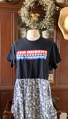 a t - shirt with the words ted nugentn is displayed on a mannequin