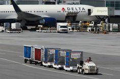 a large jetliner sitting on top of an airport tarmac next to a truck