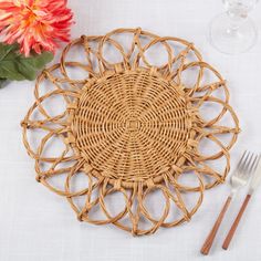 a place setting on a table with flowers and utensils