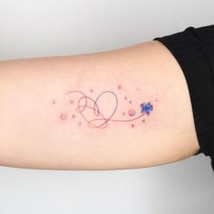 a woman's arm with a small tattoo on the left side of her arm